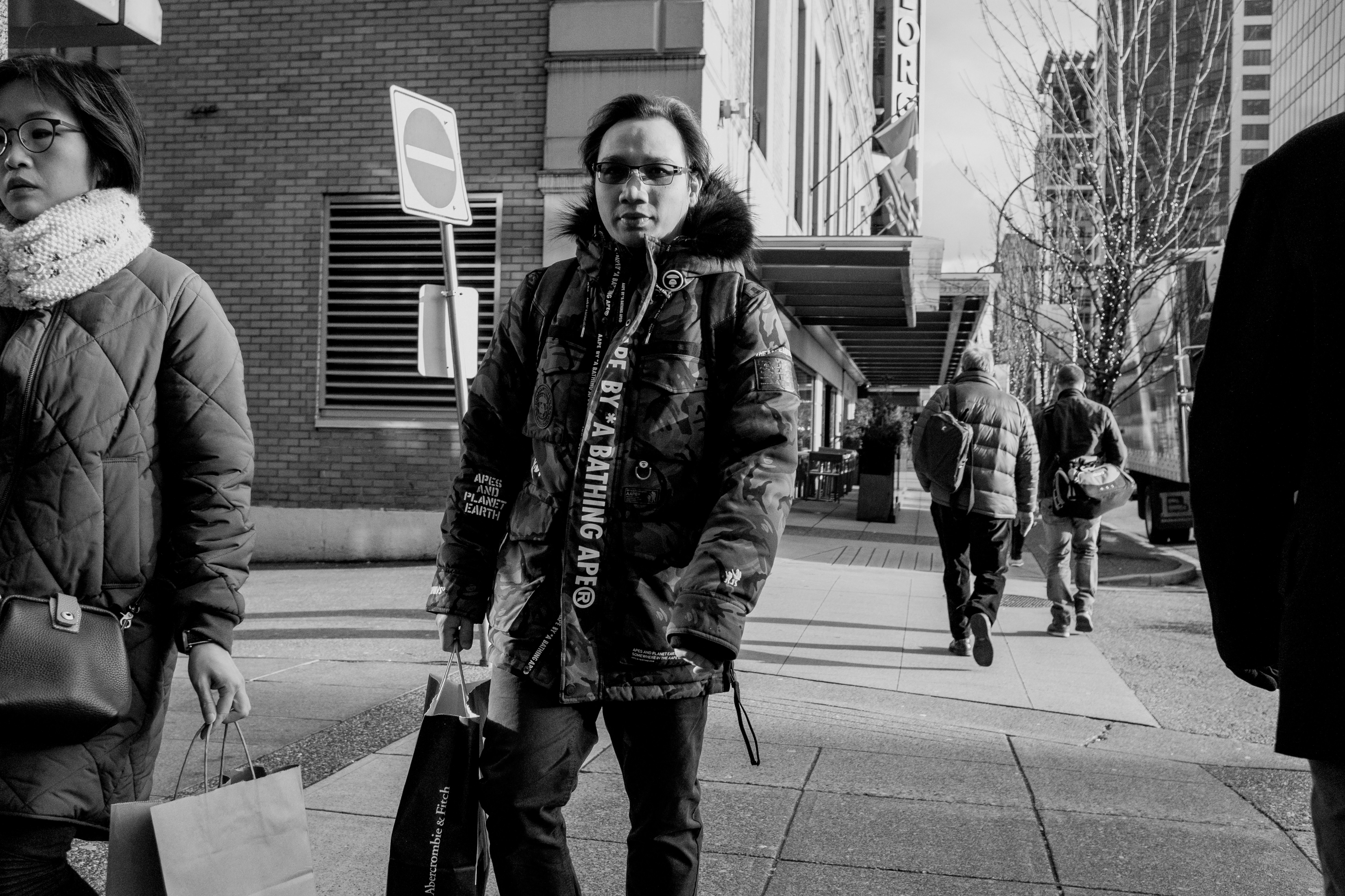 a man and woman walking down a sidewalk