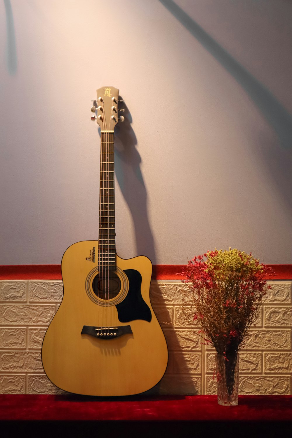 a guitar leaning against a wall