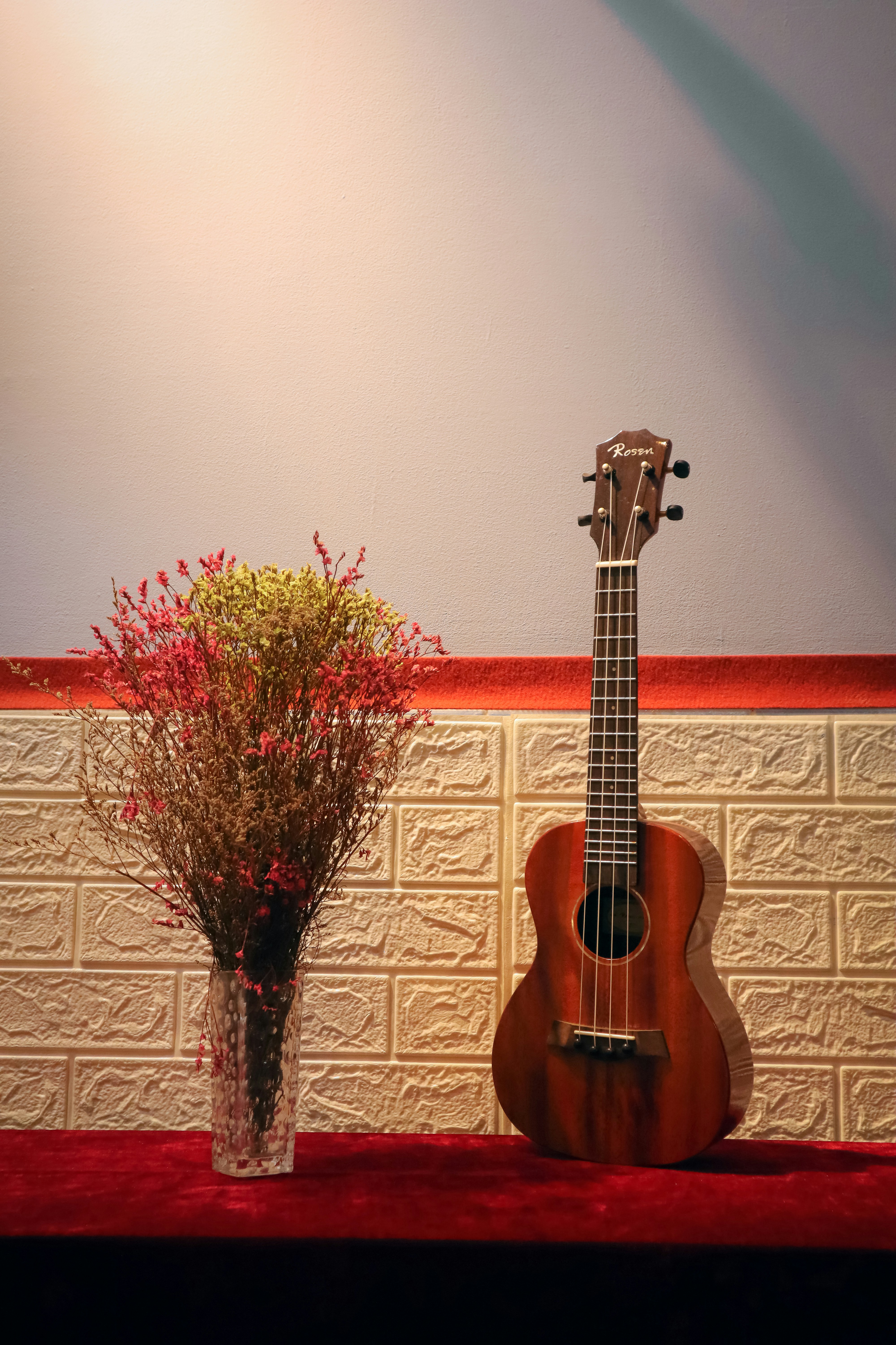 a guitar and a vase of flowers