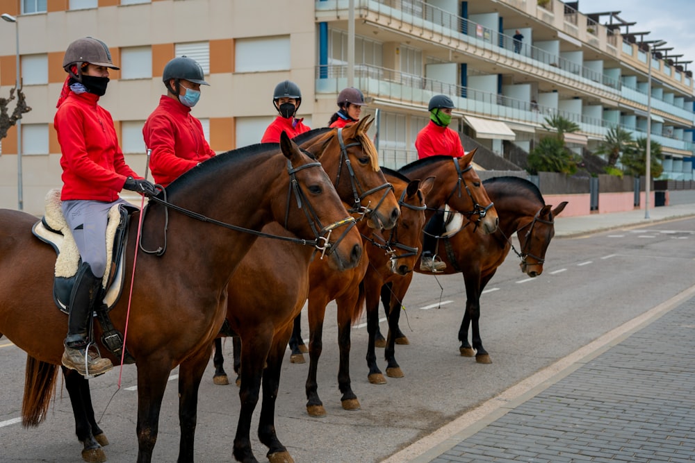 a group of people riding horses