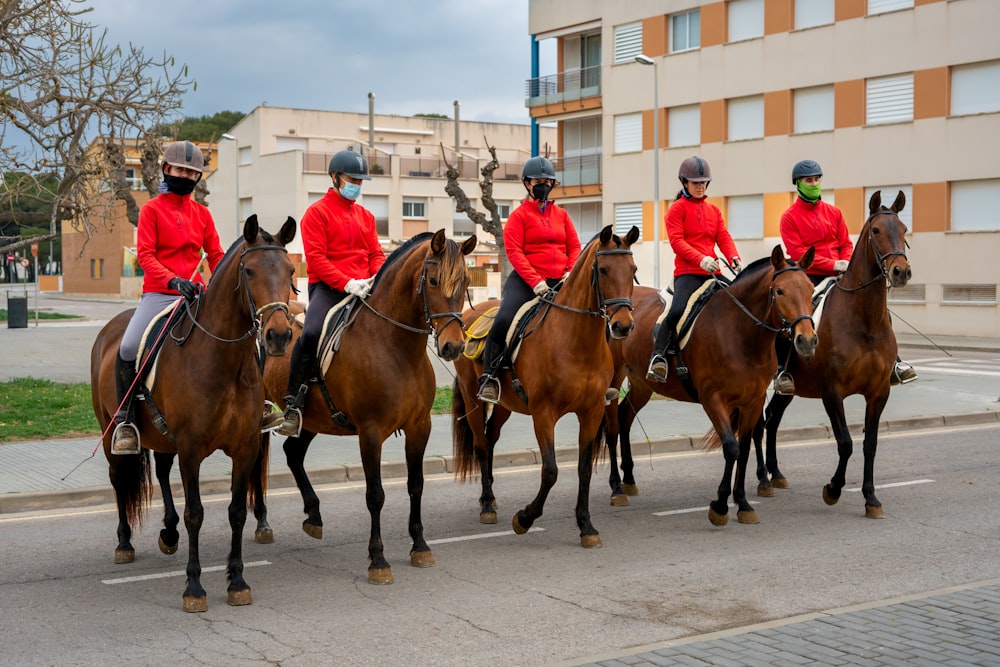 a group of people riding horses