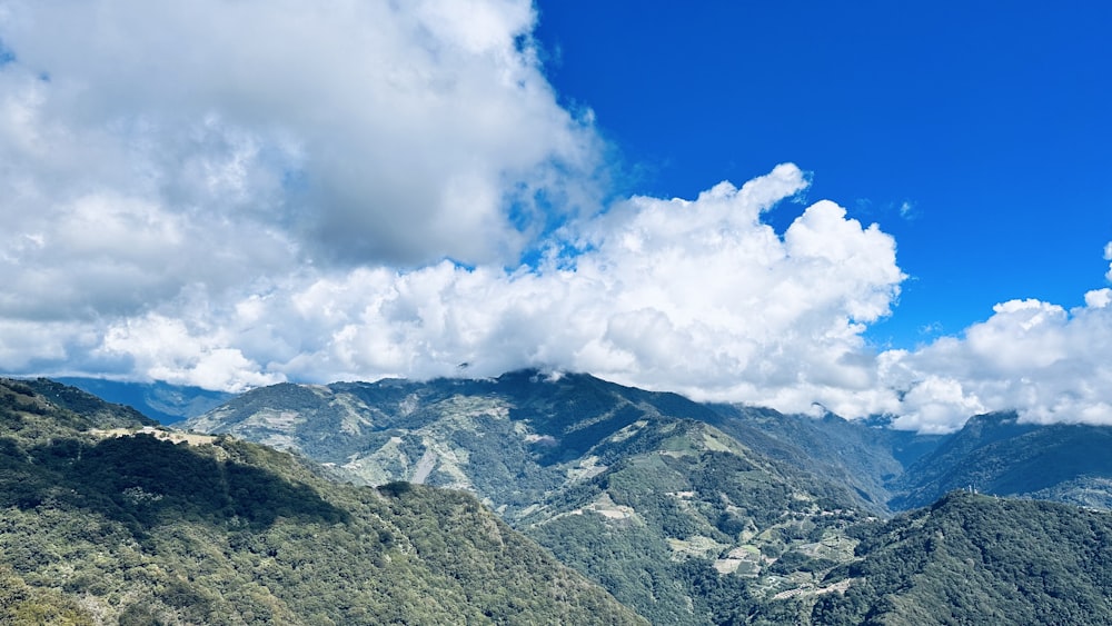 a landscape with mountains and clouds