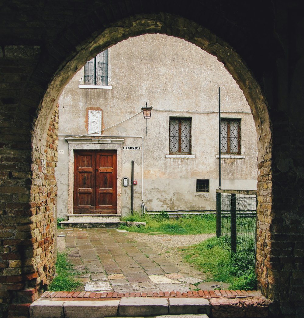 a brick building with a door with Round House in the background