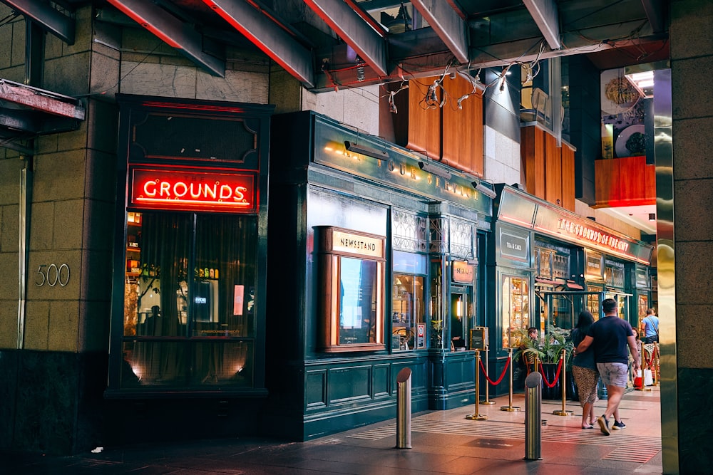 a store front with people walking by