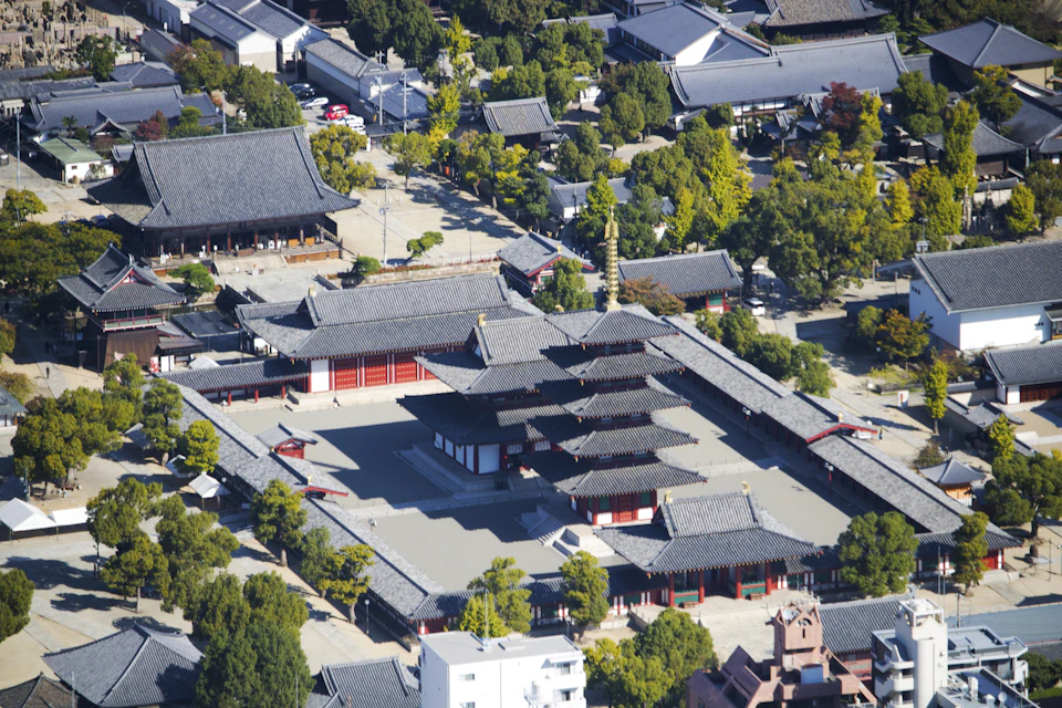 Traditional Japanese temple complex with multiple buildings in various styles and colors