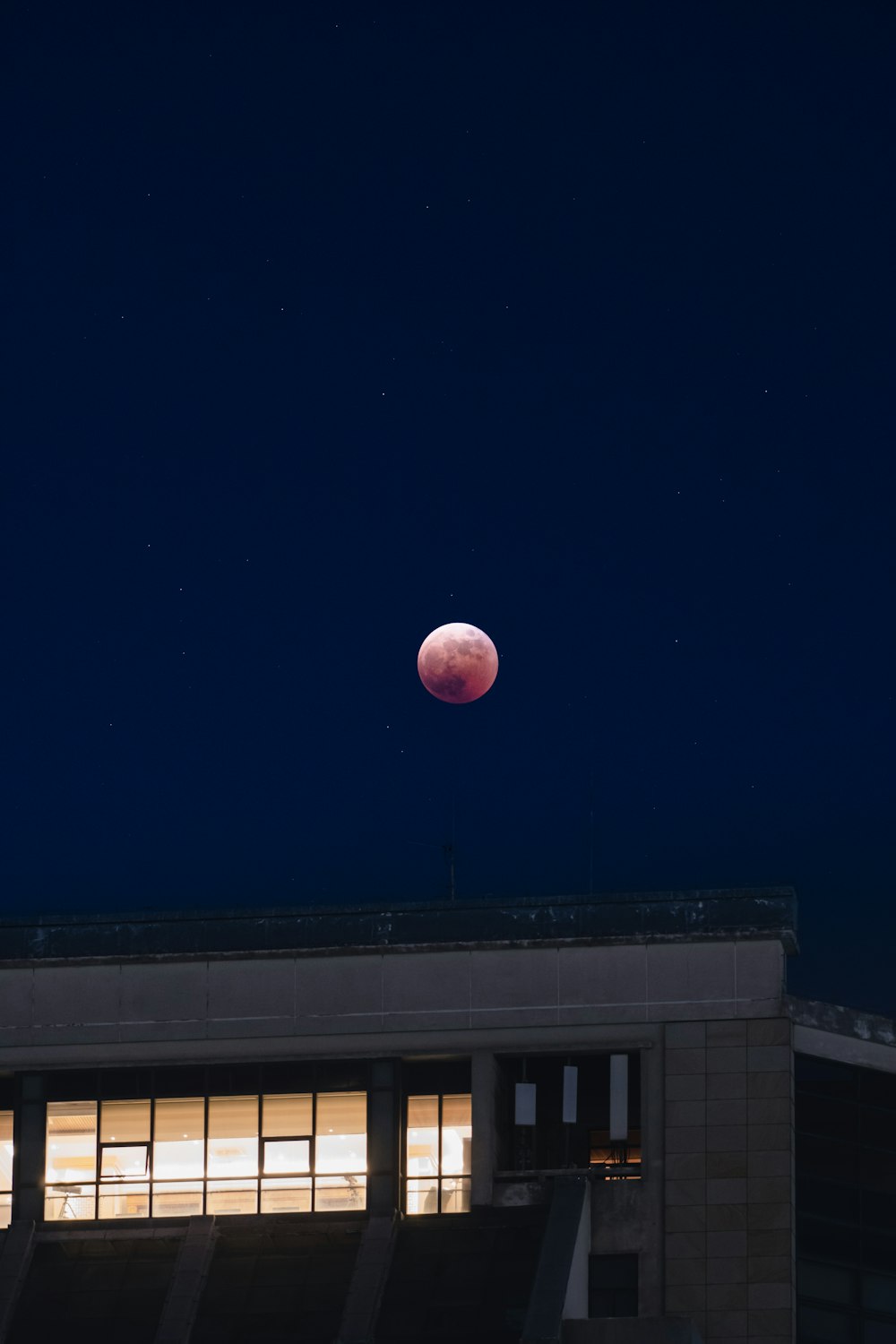 a building with a moon in the sky