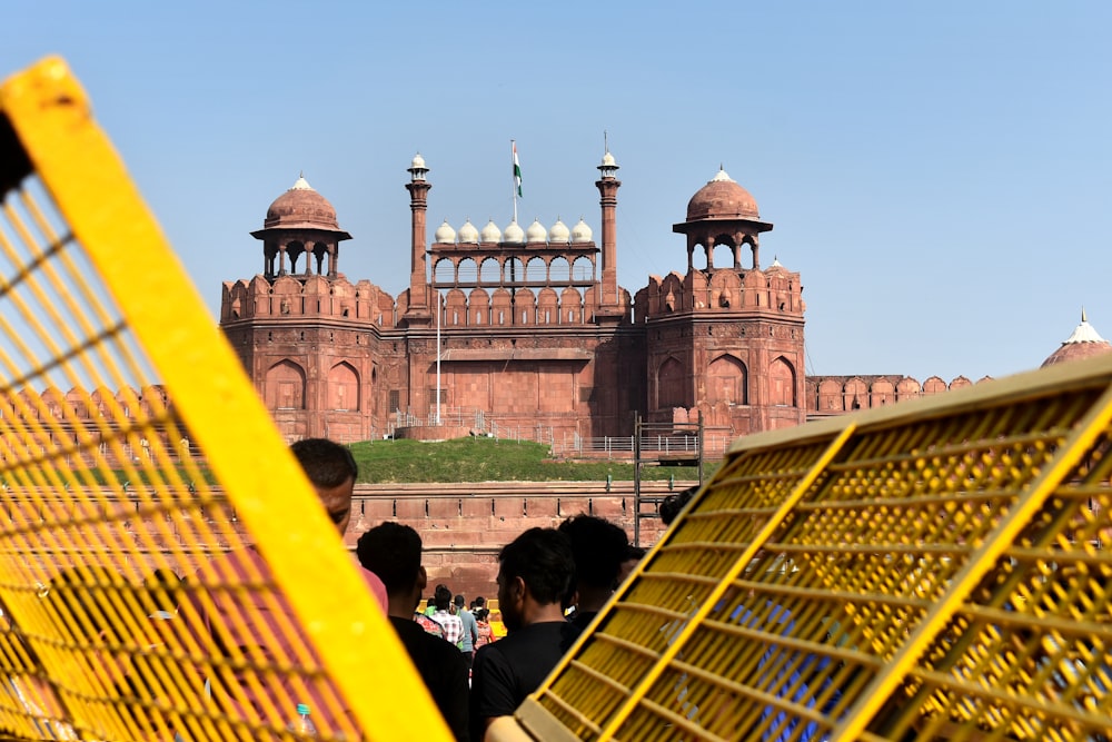 a large building with a domed roof with Red Fort in the background
