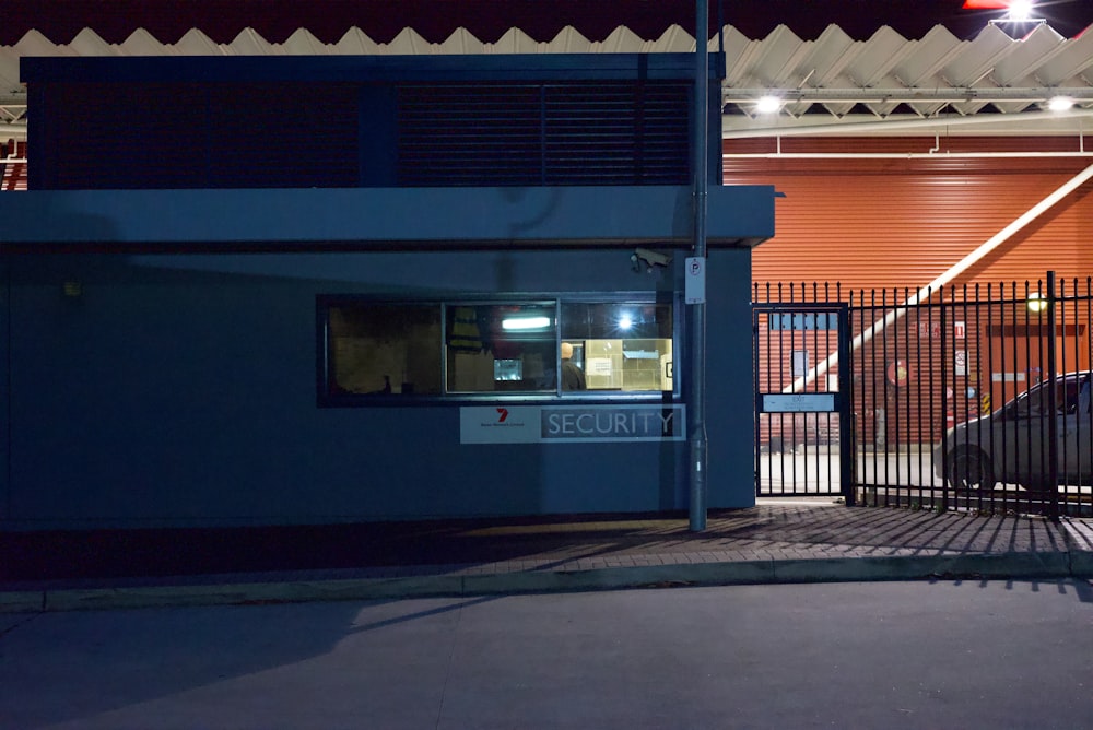 a blue building with a fence