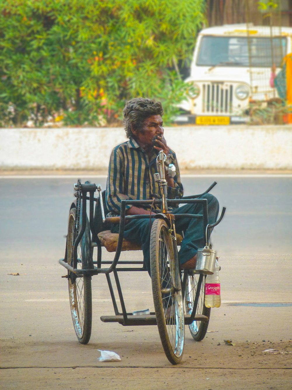 a man in a wheelchair smoking a cigarette
