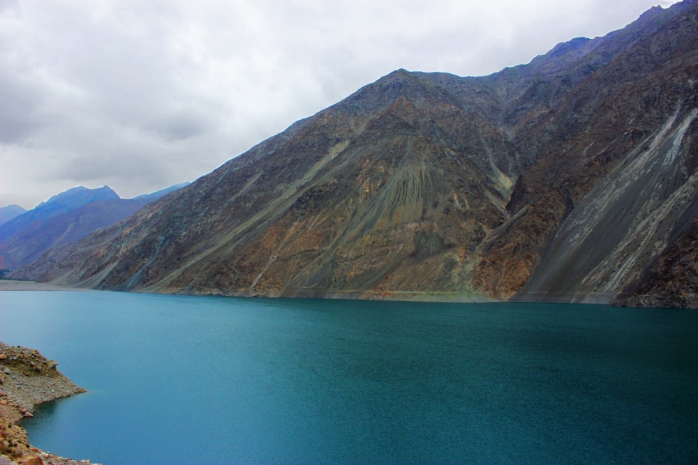 a body of water with mountains in the back