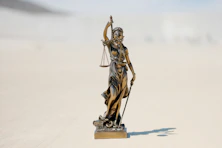 a statue of a person holding a staff