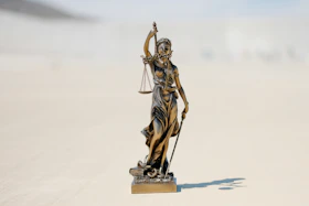 a statue of a person holding a staff