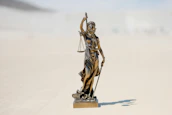 a statue of a person holding a staff