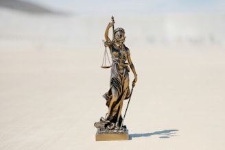 a statue of a person holding a staff