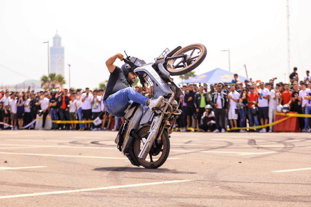 a man doing a wheelie on a motorcycle