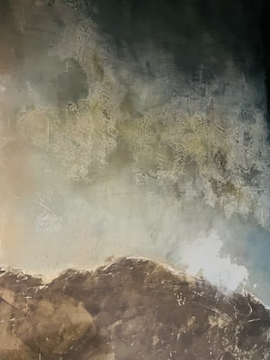 Muted earth tone landscape with layered ink textures and parchment hues.