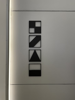 Close-up of a modern monochrome art piece featuring geometric shapes on a white background.