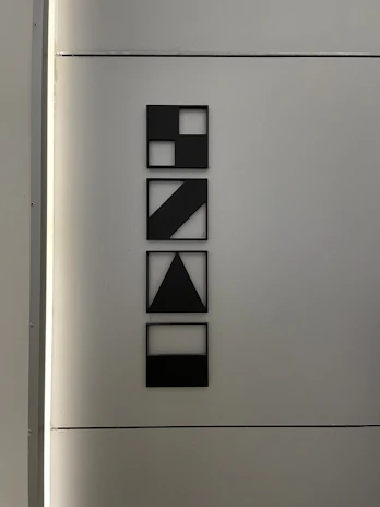 Modern geometric art piece with sharp lines and contrasting colors, framed elegantly.