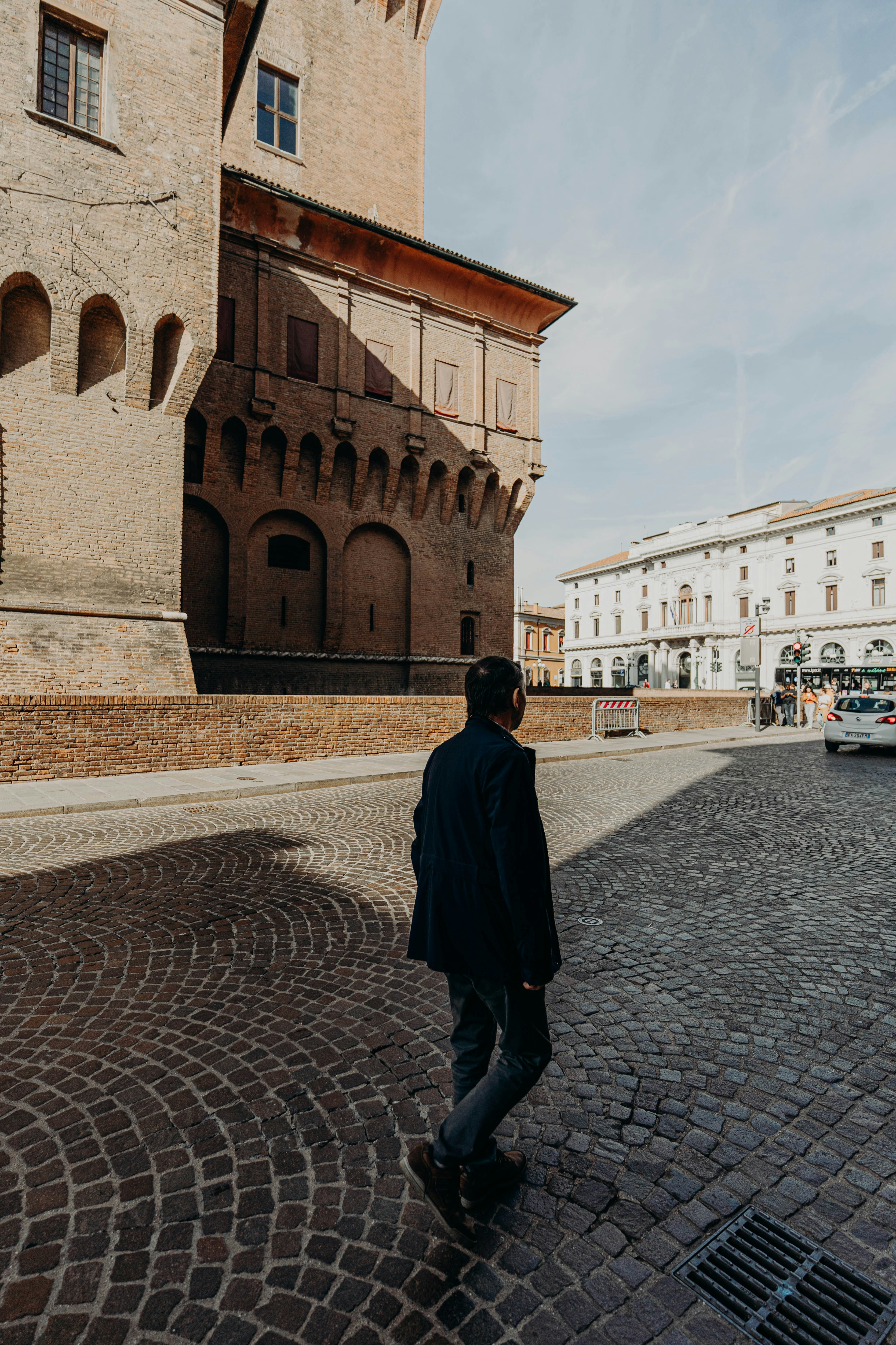 a man walking on a brick road