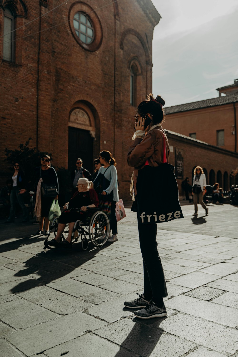 a person in a garment walking on a brick street