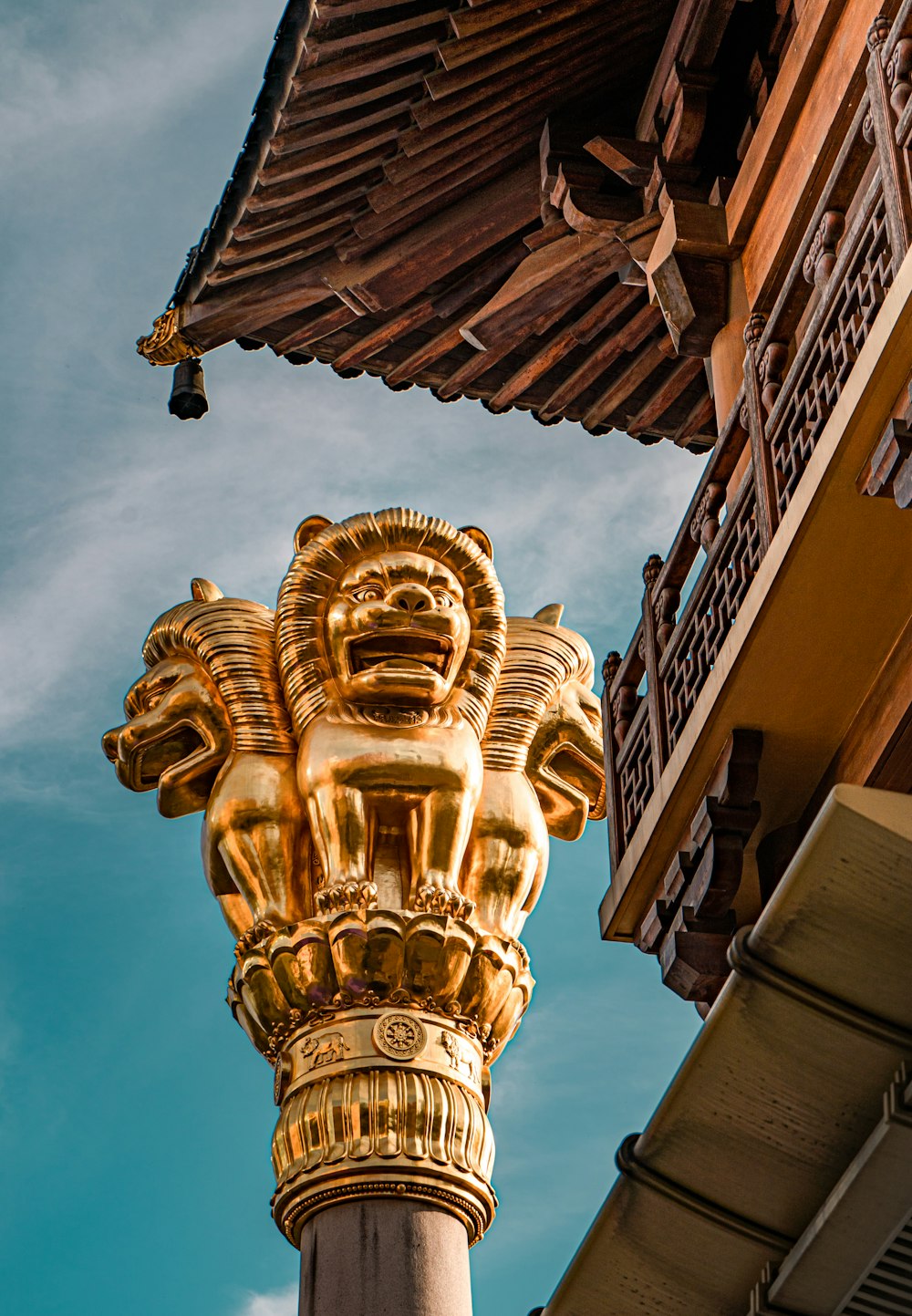 a gold statue on a pole