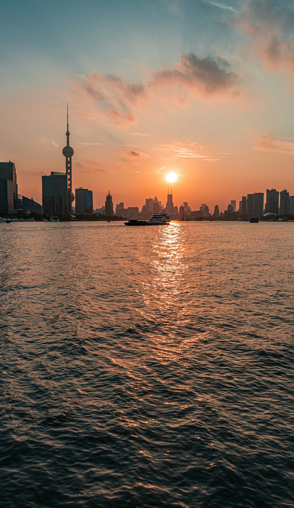 a body of water with a city in the background