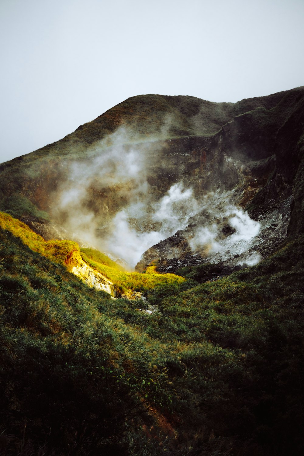 a volcano with smoke coming out of it