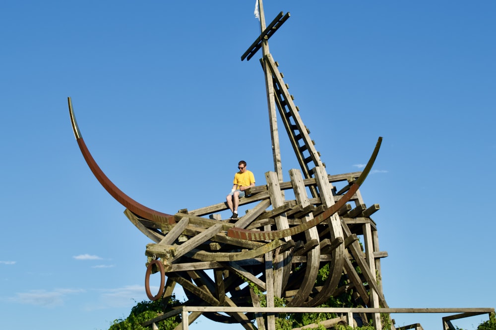 a person sitting on a wooden structure