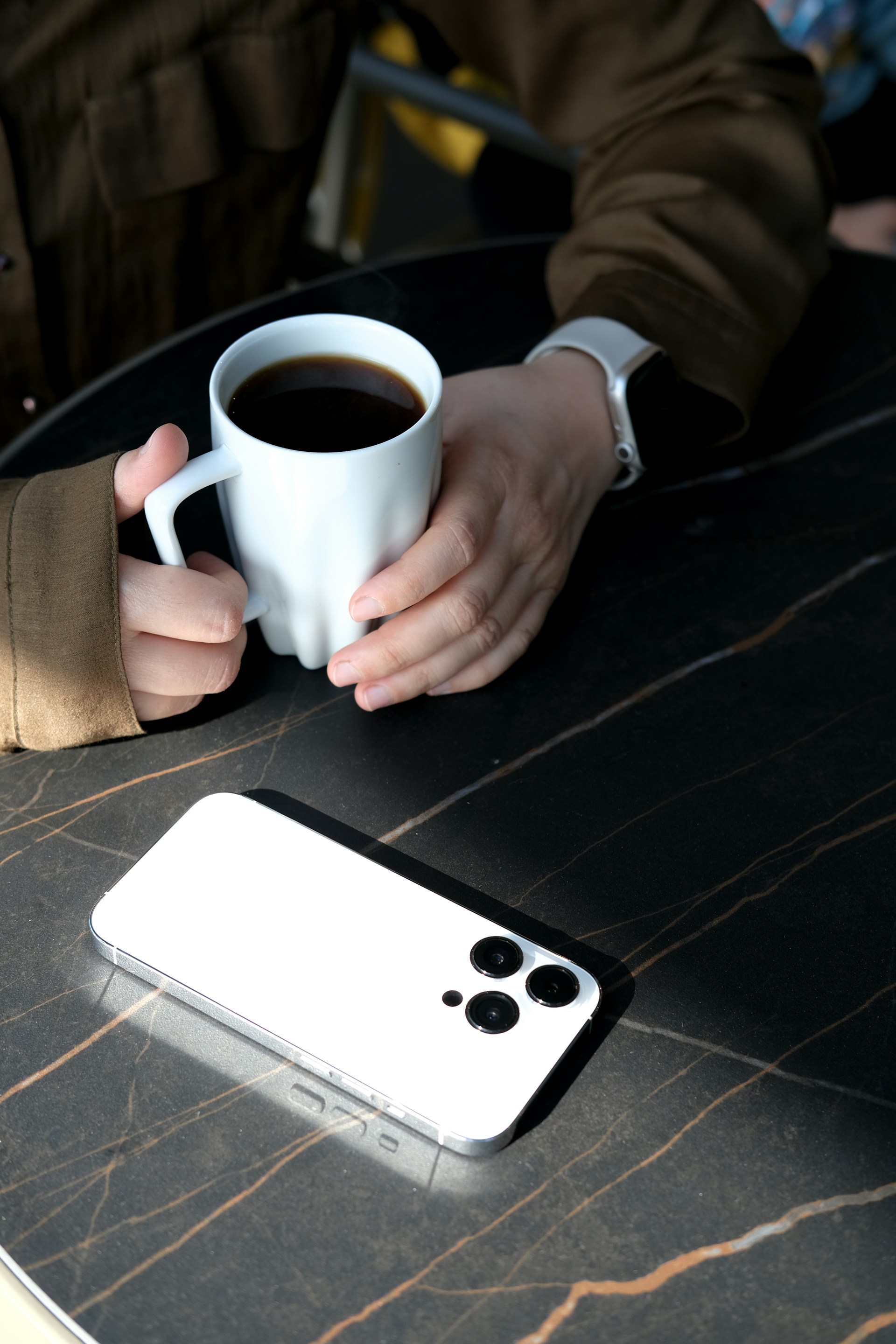 a person holding a cup of coffee
