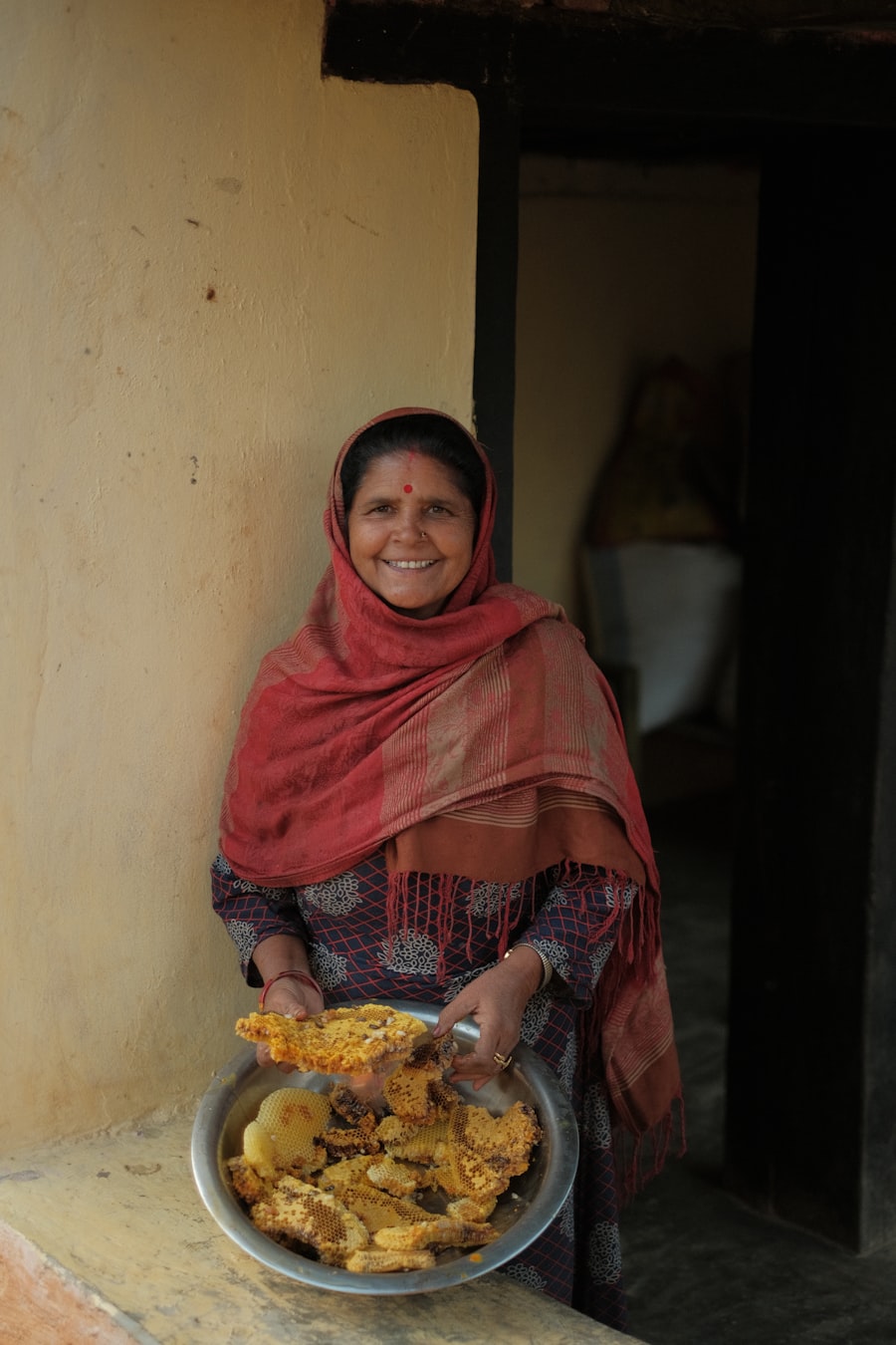 A smiling woman in a red shawl