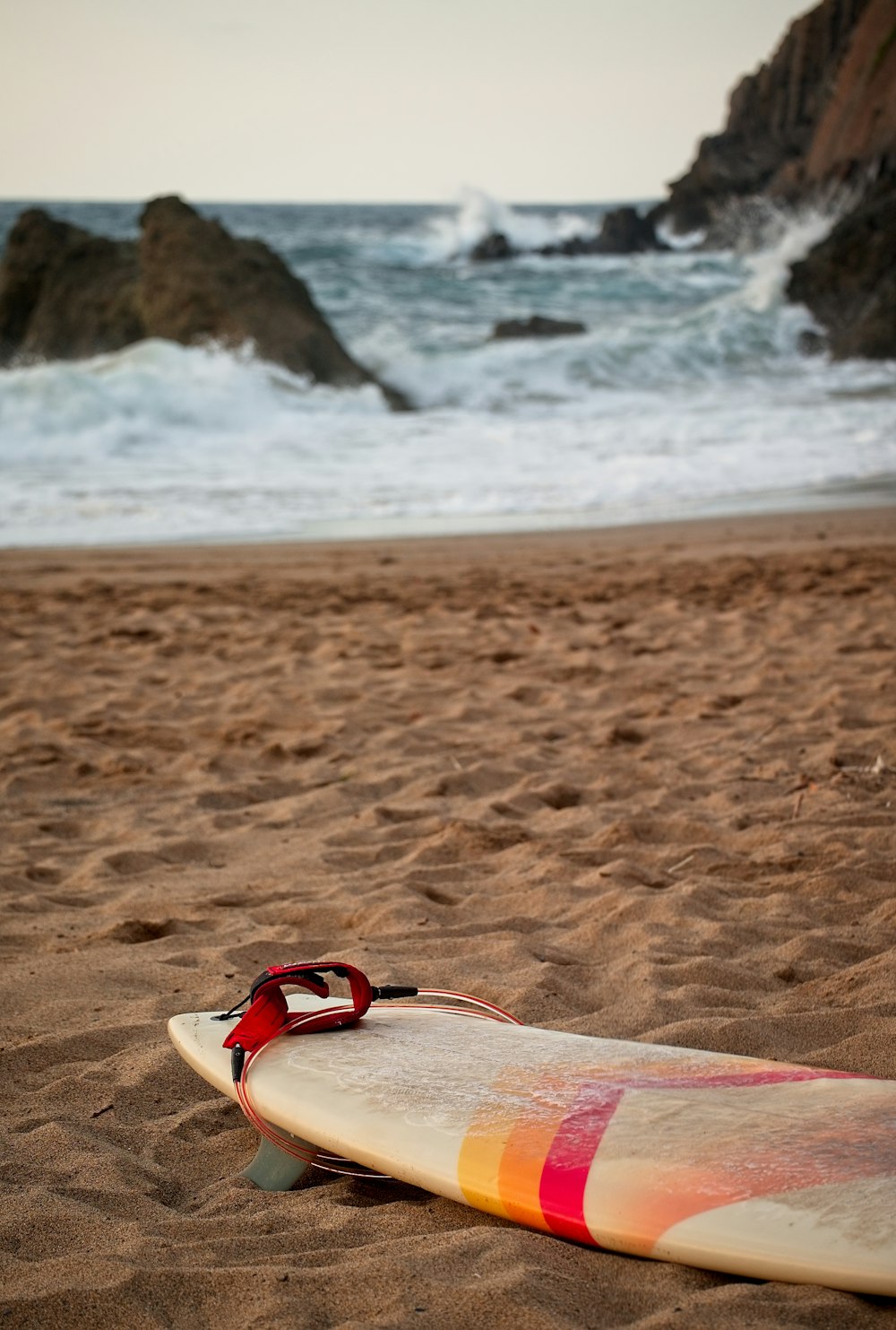 a surfboard on a beach