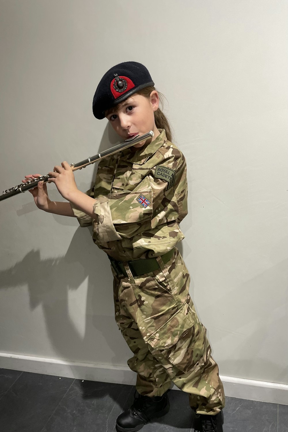 a person in military uniform holding a gun