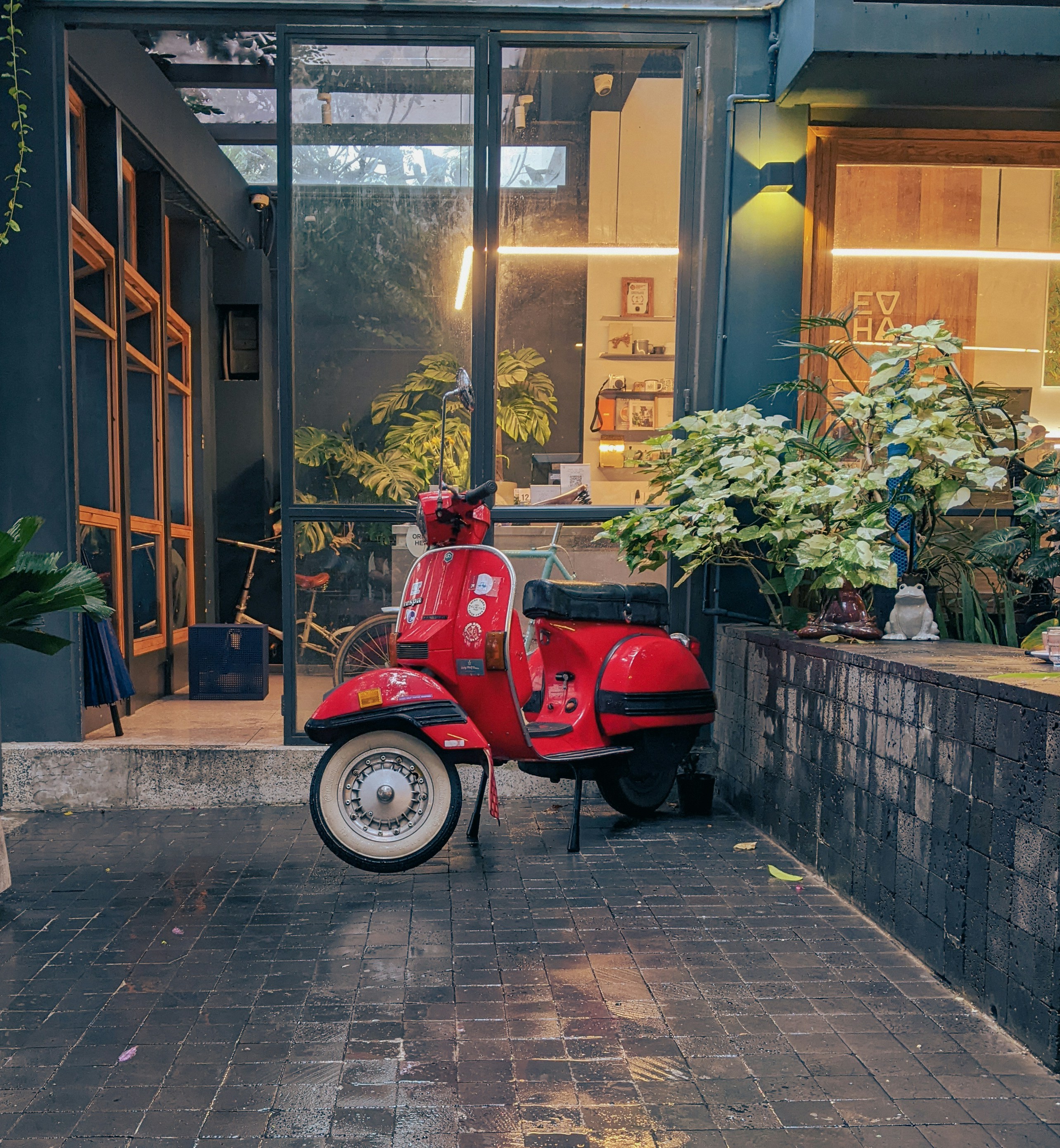 a red scooter parked outside a building
