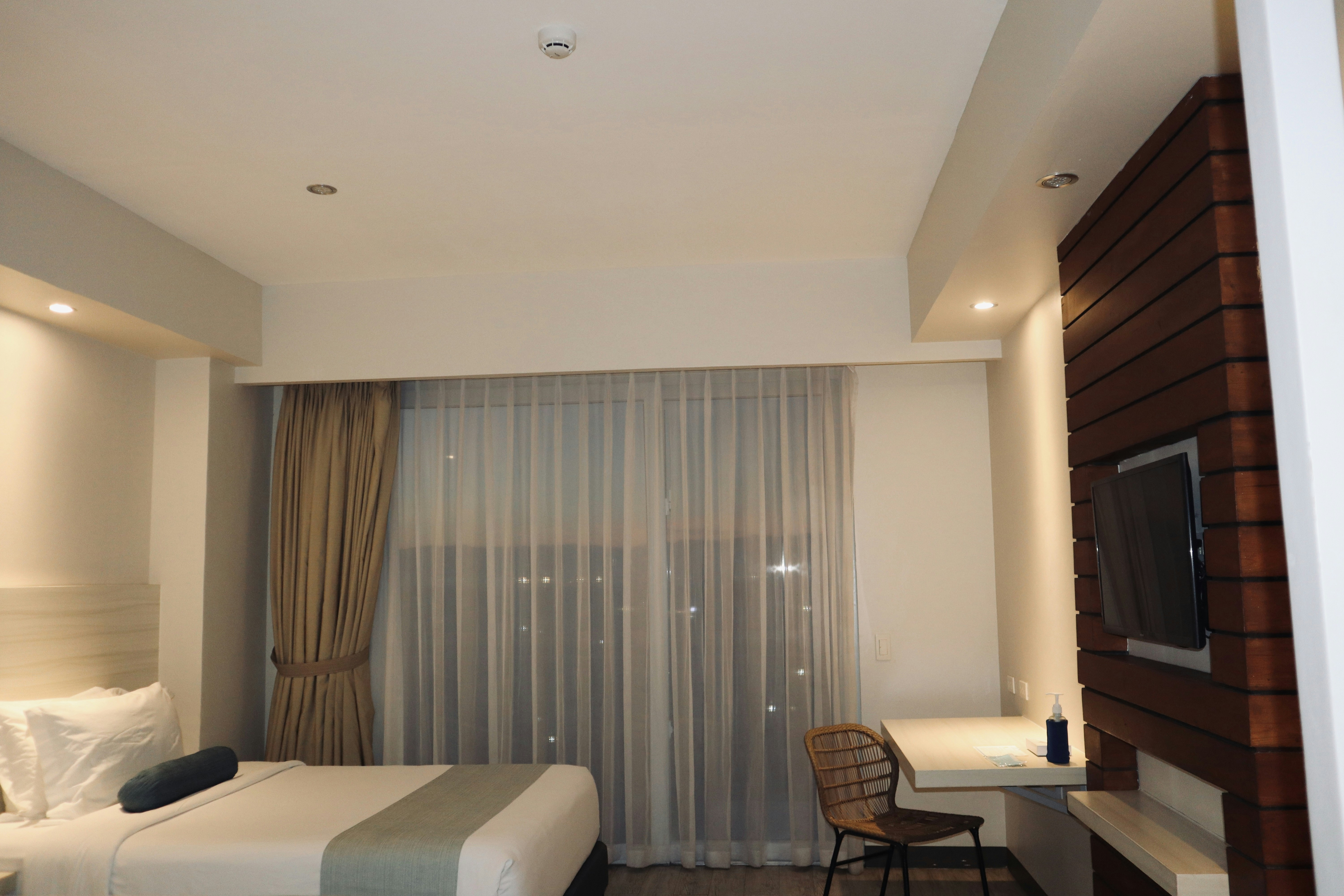 a hotel room with a tv and a bed