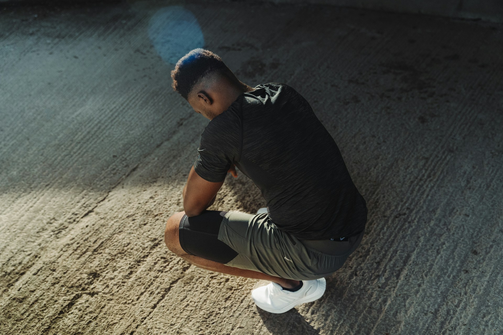 a man squatting down on the ground