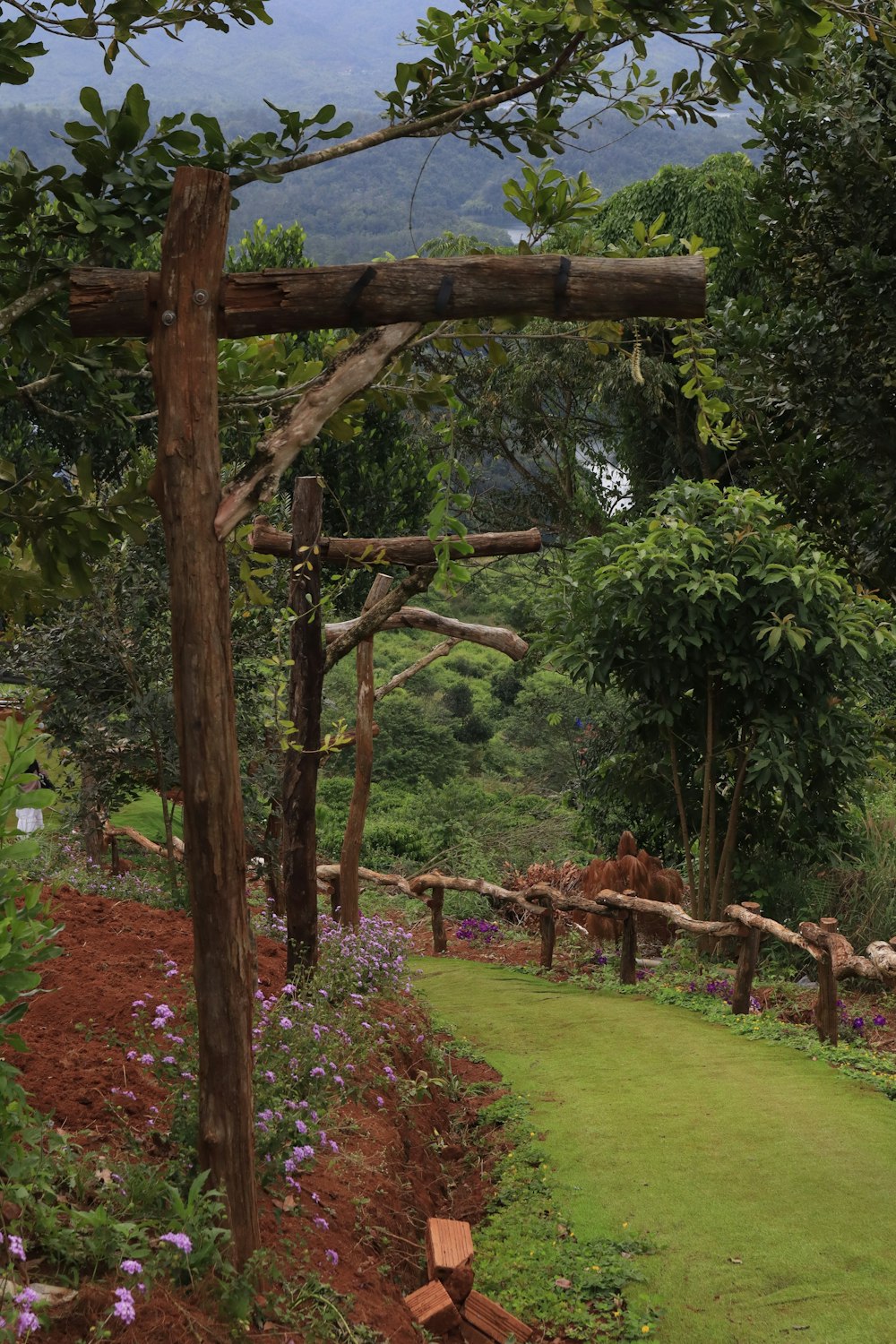 a garden with a fence and trees