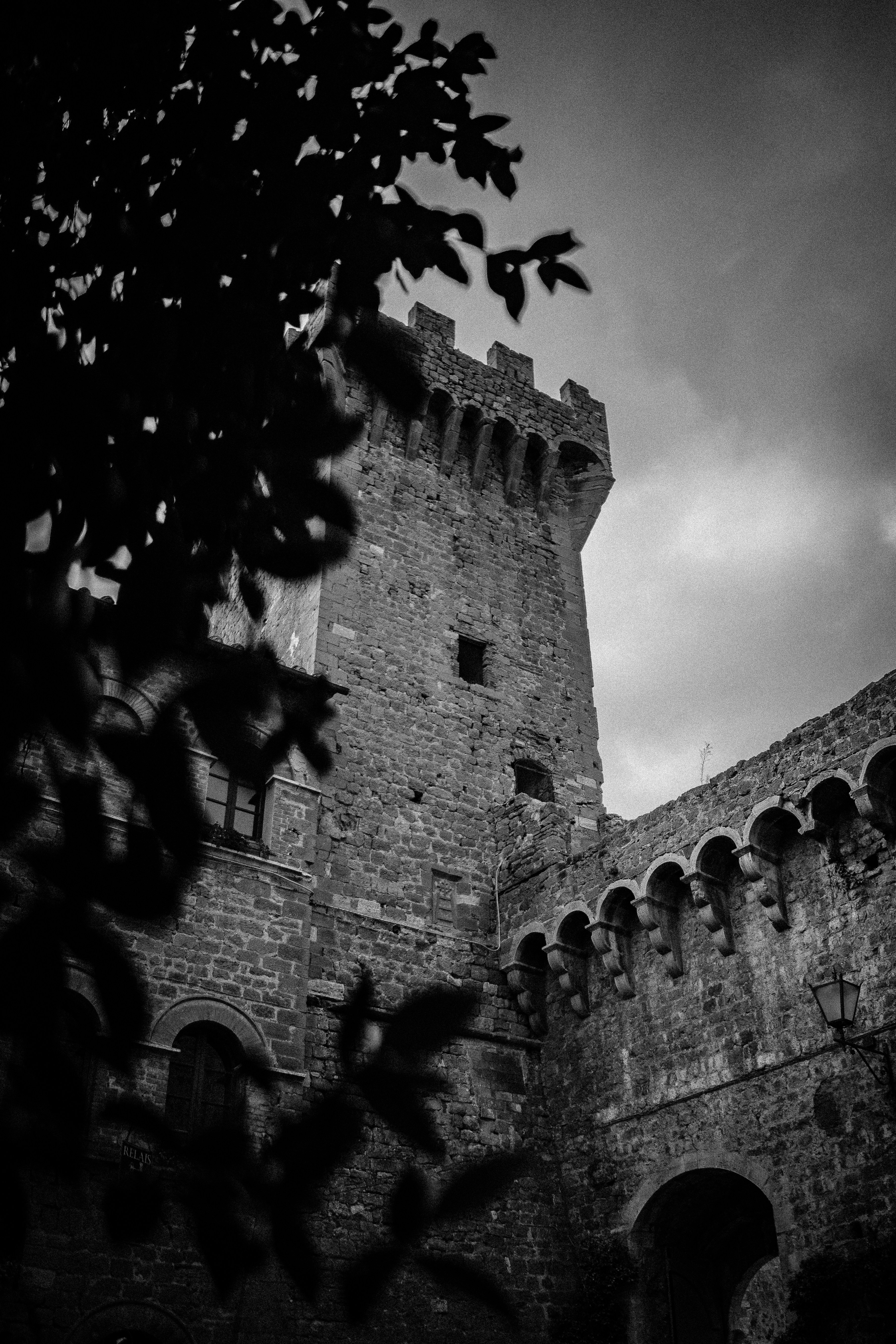 a stone building with a tree in front of it