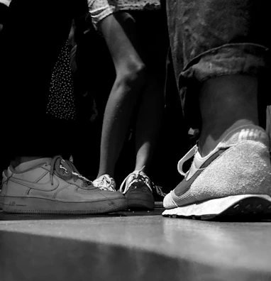 A joyful group photo of the shoeless ones team and local families after a donation event.