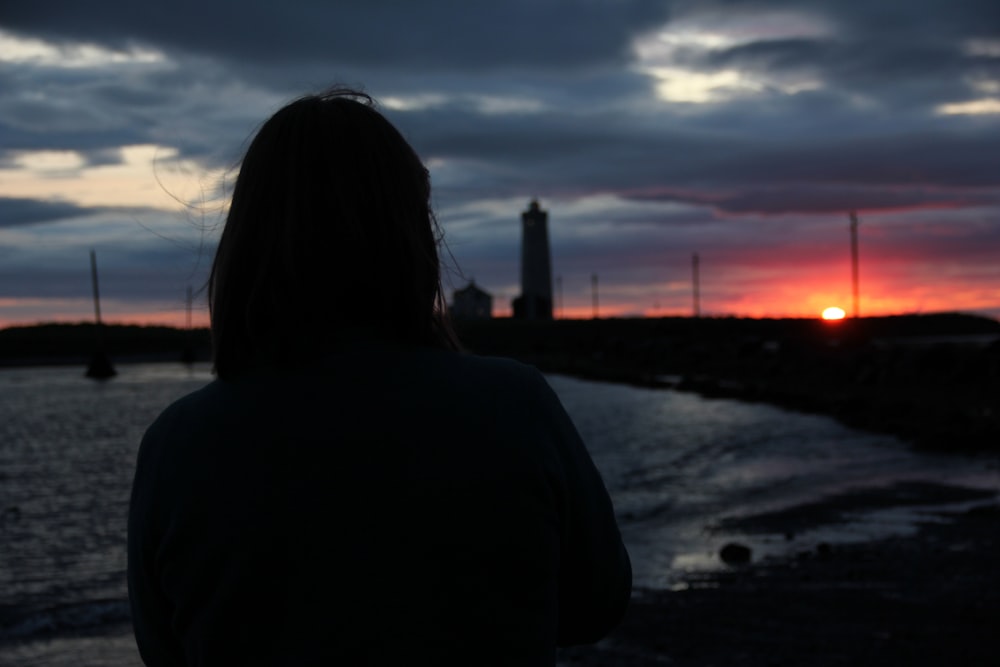 a person looking at a sunset