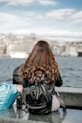 a person sitting on a bench looking out over the water