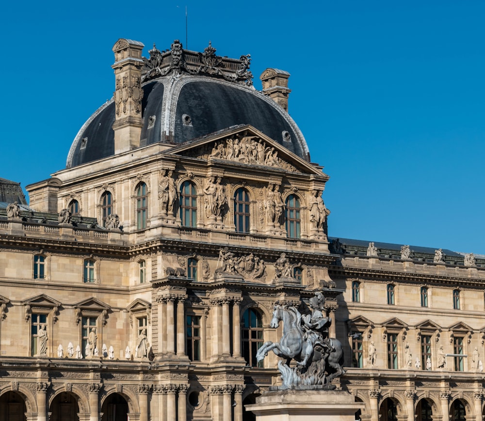 a large building with a statue in front of it