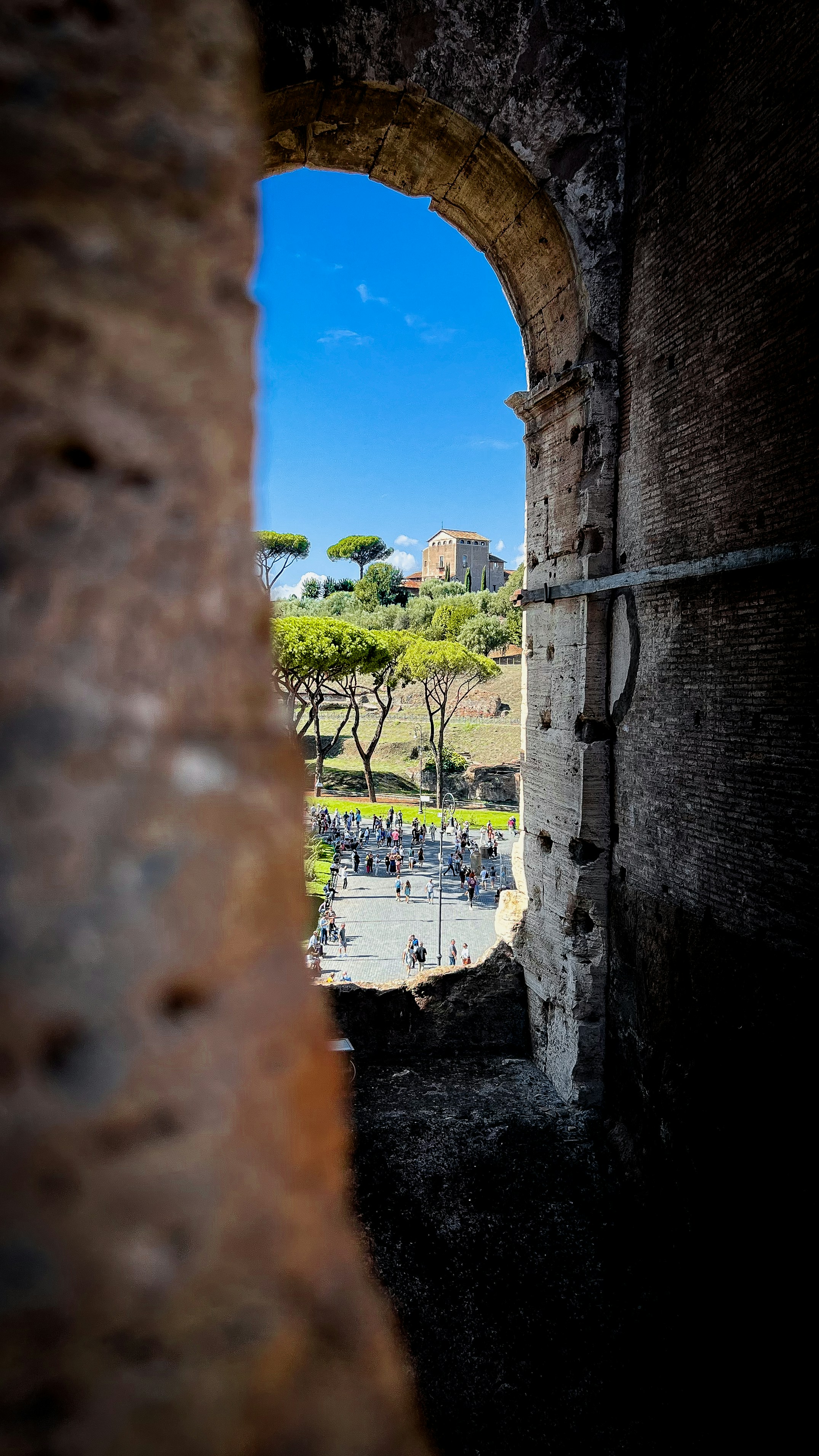 a view through a window of a street and people walking on a path