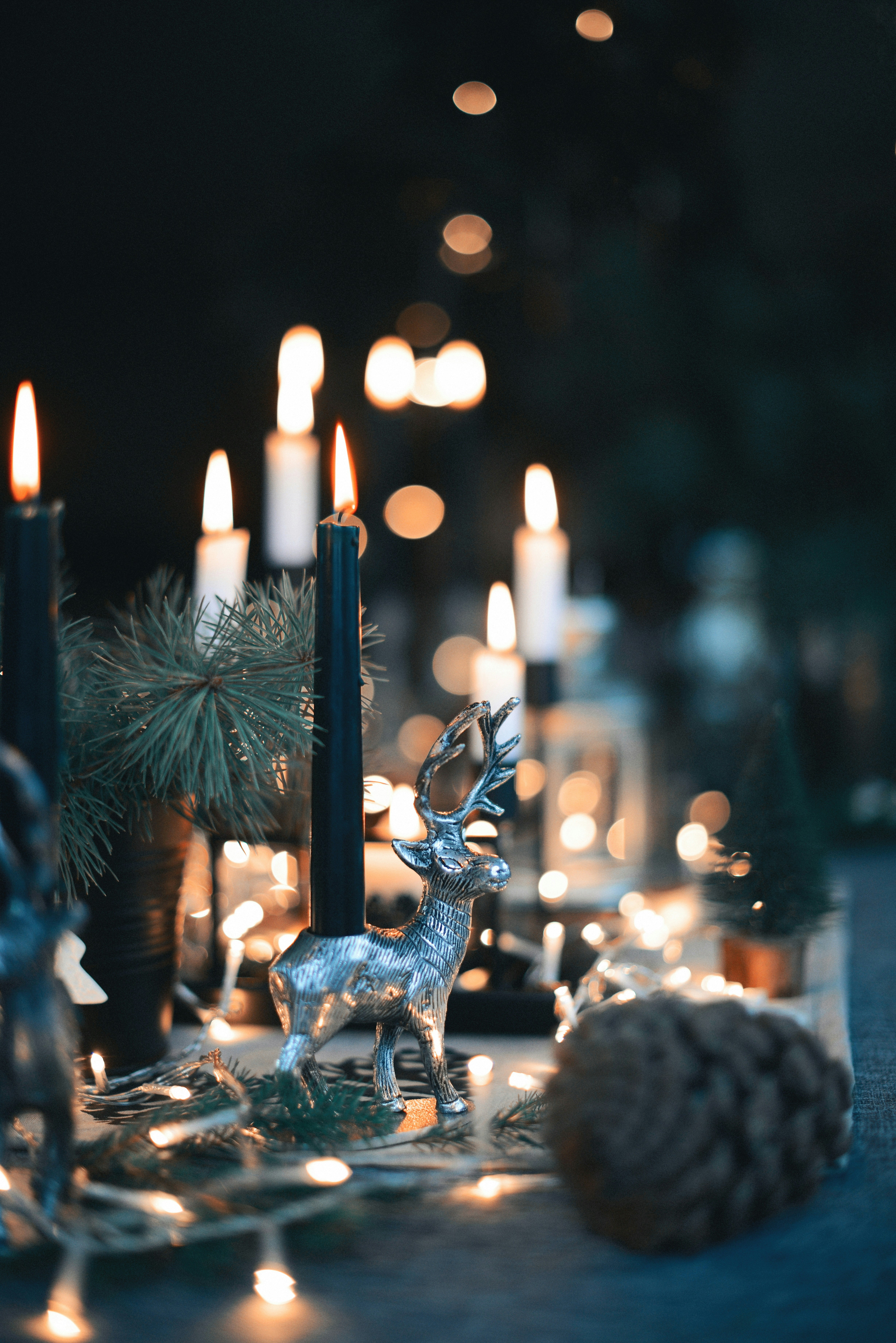 a statue of a deer with lit candles