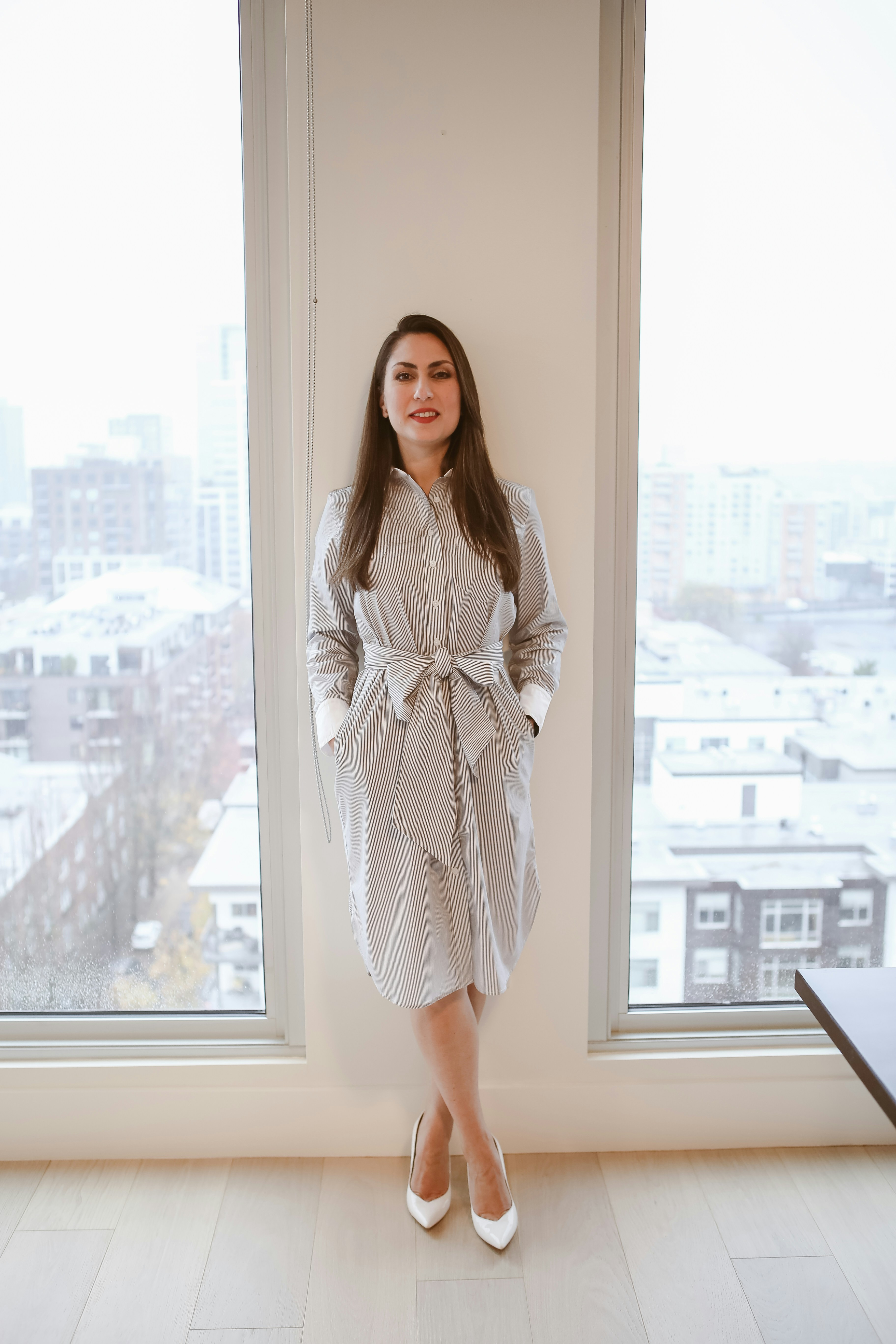 Une femme posant devant une fenêtre