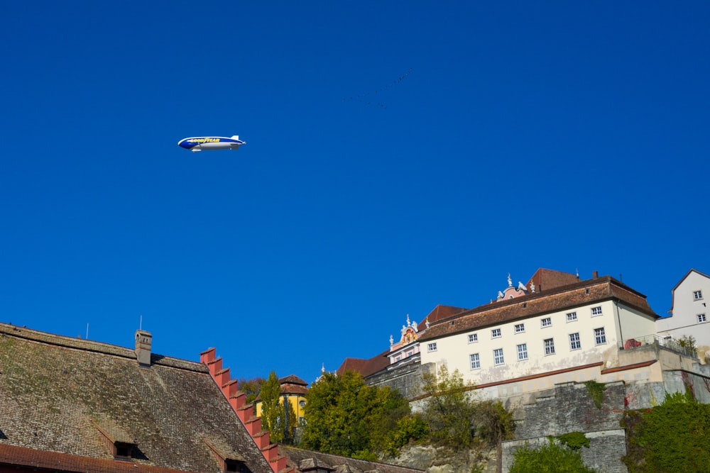 a plane flying over buildings