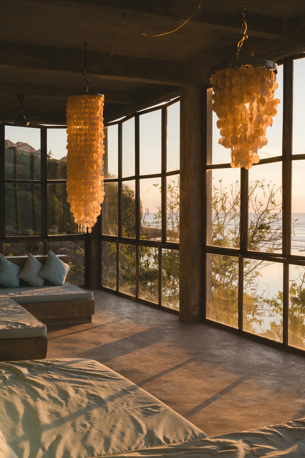 a chandelier from a ceiling in a room with windows