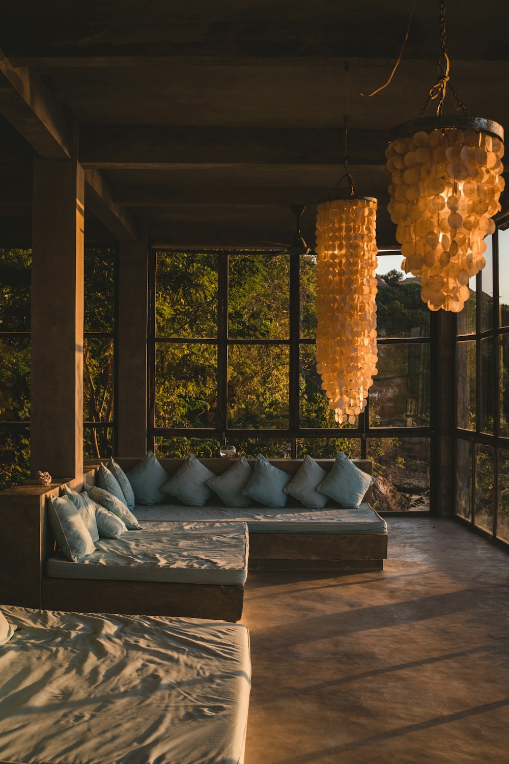 a living room with a couch and a window with lights