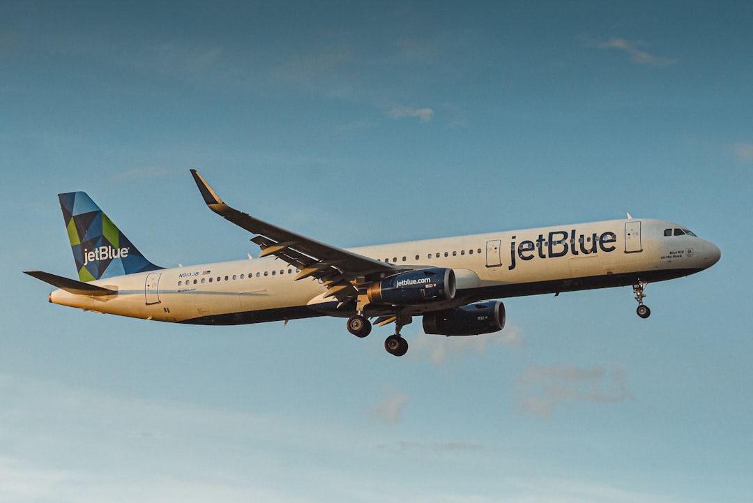 a large airplane flying in the sky, N913JB | Airbus A321-231