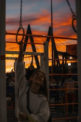 Athlete performing a perfect muscle-up on gymnastic rings outdoors at sunrise