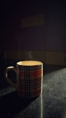 A cozy ceramic mug with a unique, hand-drawn pattern glowing in natural light.